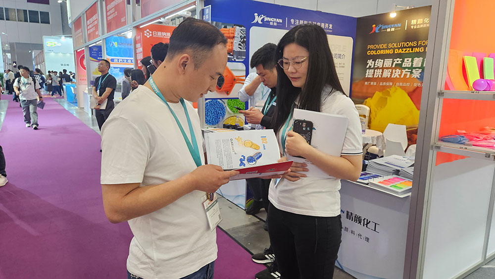观众在精颜化工展位体验产品手册